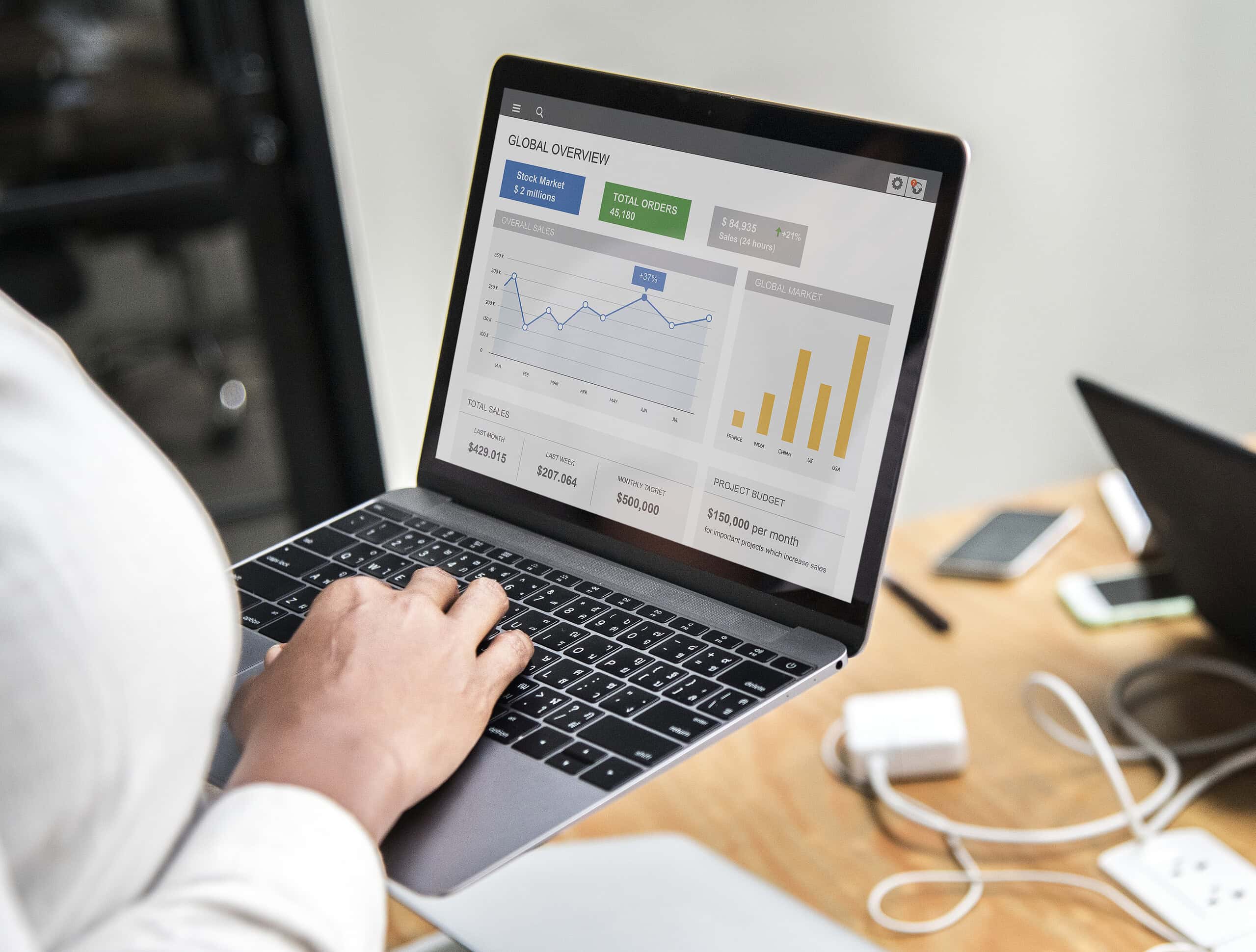Professional developer analyzing Web Analytics Italia dashboards on a laptop to optimize e-commerce conversion tracking.